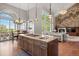 Open kitchen and dining area with a large island, stainless steel appliances, and lovely views of the outdoors at 6299 Ellingwood Point Pl, Castle Rock, CO 80108