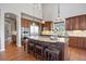 Chef's kitchen with stainless steel appliances, granite countertops, and large island with bar seating at 6299 Ellingwood Point Pl, Castle Rock, CO 80108