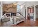 Comfortable living room with hardwood floors, cozy fireplace, and wet bar that leads to an upper-level staircase at 6299 Ellingwood Point Pl, Castle Rock, CO 80108