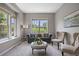Cozy living room with a plush sofa, stylish chairs, and large windows offering ample natural light at 6299 Ellingwood Point Pl, Castle Rock, CO 80108