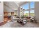 Open-concept living space with soaring ceilings, a view of the gourmet kitchen, and abundant natural light at 6299 Ellingwood Point Pl, Castle Rock, CO 80108