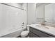 Clean bathroom with white tile, toilet, gray cabinets, and a single sink with white countertop at 2512 Lupton Ln, Lafayette, CO 80026