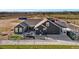 Aerial view of modern home, backyard, and patio, surrounded by landscaping at 359 Josef Cir, Fort Lupton, CO 80621