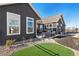 Spacious backyard with patio area, manicured lawn, and modern home exterior at 359 Josef Cir, Fort Lupton, CO 80621