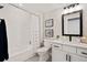 Well-lit bathroom with shower/tub combo, white tile, modern fixtures, and vanity at 359 Josef Cir, Fort Lupton, CO 80621