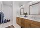 Contemporary bathroom with double vanity, sleek fixtures, and walk-in shower at 359 Josef Cir, Fort Lupton, CO 80621