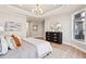 Lovely bedroom boasts tray ceilings, a plush rug, and beautiful light-colored wood flooring at 359 Josef Cir, Fort Lupton, CO 80621