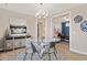 Bright dining room with elegant lighting and decor, open to office, and with wood flooring at 359 Josef Cir, Fort Lupton, CO 80621