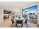 Bright dining room with kitchen access, deck access, neutral paint and a modern chandelier at 359 Josef Cir, Fort Lupton, CO 80621
