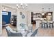 Dining room featuring a glass top table and view to kitchen with a counter and barstool seating at 359 Josef Cir, Fort Lupton, CO 80621