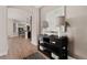 Open entryway with hardwood floors, decorative console table, and view of the dining room at 359 Josef Cir, Fort Lupton, CO 80621