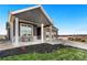 Inviting front porch with seating area, stone accents, and well-maintained landscaping at 359 Josef Cir, Fort Lupton, CO 80621