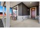 Cozy front porch with seating area, stone accents, and a view of the neighborhood at 359 Josef Cir, Fort Lupton, CO 80621