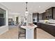 Modern kitchen with an island, pendant lighting, stainless steel appliances, and dark cabinetry at 359 Josef Cir, Fort Lupton, CO 80621