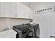Well-equipped laundry room with modern machines and plenty of storage space at 359 Josef Cir, Fort Lupton, CO 80621