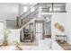 Bright foyer featuring a staircase with wooden steps and decorative iron railings, plus light hardwood floors at 27500 E Lakeview Dr, Aurora, CO 80016