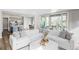Comfortable living room, offering a view of the kitchen and patio through sliding glass doors at 27500 E Lakeview Dr, Aurora, CO 80016