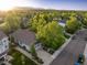 Panoramic aerial view of the home, neighborhood, and mountain backdrop at sunset at 6480 Moss Cir, Arvada, CO 80007