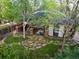Aerial view of a landscaped backyard with covered patio, outdoor kitchen and lush lawn at 6480 Moss Cir, Arvada, CO 80007