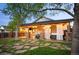 Inviting covered patio with outdoor kitchen, hot tub, string lights and stone pathway at 6480 Moss Cir, Arvada, CO 80007