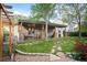 Charming backyard featuring a covered patio, string lights, and a beautiful stone pathway at 6480 Moss Cir, Arvada, CO 80007
