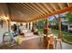 Spacious backyard features a covered patio, outdoor kitchen, hot tub and dining area at 6480 Moss Cir, Arvada, CO 80007