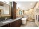 Modern bathroom with a soaking tub, walk-in shower, double vanity, and contemporary fixtures, creating a spa-like experience at 6480 Moss Cir, Arvada, CO 80007