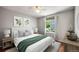 Cozy bedroom featuring a large window, fresh paint, and ample natural light at 6480 Moss Cir, Arvada, CO 80007