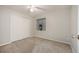Bedroom with carpet, ceiling fan, closet, neutral paint and large window at 6480 Moss Cir, Arvada, CO 80007
