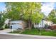 Charming single-Gathering home with a well-manicured lawn and a for sale sign at 6480 Moss Cir, Arvada, CO 80007