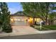 Charming home with a well-manicured lawn, mature trees, and an attached two-car garage, creating great curb appeal at 6480 Moss Cir, Arvada, CO 80007