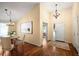 Inviting foyer with high ceilings, hardwood floors, and modern chandeliers at 6480 Moss Cir, Arvada, CO 80007