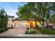 Inviting home exterior with a landscaped front yard, warm lighting, and a welcoming entrance at 6480 Moss Cir, Arvada, CO 80007