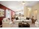 Bright living room with vaulted ceilings, skylights, and an open floor plan to the modern kitchen at 6480 Moss Cir, Arvada, CO 80007
