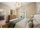 Serene bedroom features a vaulted ceiling, a private deck, and an ensuite bathroom at 6480 Moss Cir, Arvada, CO 80007