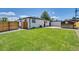 Backyard showcasing a green lawn, fence, and additional storage shed at 7826 Joan Dr, Denver, CO 80221