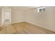 Basement room with hardwood floors, recessed lighting, and a small window at 7826 Joan Dr, Denver, CO 80221