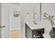 Bathroom with dark vanity, neutral paint and flooring, plus decorative plant and mirror at 7826 Joan Dr, Denver, CO 80221
