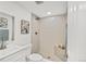 Bathroom features tiled shower with glass door, modern fixtures, and tile flooring at 7826 Joan Dr, Denver, CO 80221
