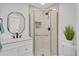 Bright bathroom features a shower with glass door, modern fixtures, and tiled shower at 7826 Joan Dr, Denver, CO 80221