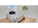 Bedroom with hardwood floors and two windows providing natural light at 7826 Joan Dr, Denver, CO 80221