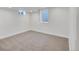Finished basement bedroom features carpet and light from two windows at 7826 Joan Dr, Denver, CO 80221