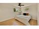 Bright bedroom with hardwood floors, ceiling fan, and two windows for ample natural light at 7826 Joan Dr, Denver, CO 80221