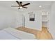 Bright bedroom with hardwood floors, ceiling fan, and ensuite bathroom and walk-in closet at 7826 Joan Dr, Denver, CO 80221