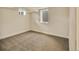 Finished basement bedroom features carpet and light from two windows at 7826 Joan Dr, Denver, CO 80221