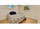 Bedroom with hardwood floors and two windows providing natural light at 7826 Joan Dr, Denver, CO 80221