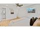 Primary bedroom with hardwood floors, bright window, ensuite bathroom at 7826 Joan Dr, Denver, CO 80221