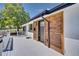 Charming front porch featuring a wooden accent wall and white railing at 7826 Joan Dr, Denver, CO 80221