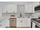 Updated kitchen with white cabinets, stainless steel appliances, and quartz countertops at 7826 Joan Dr, Denver, CO 80221