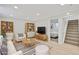 Staged living room with modern furnishings, cabinets and adjacent bedroom at 7826 Joan Dr, Denver, CO 80221